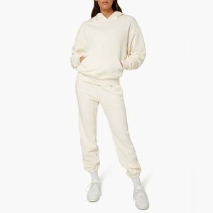 Weworewhat matching hoodie and jogger sweatpants set in color ivory.